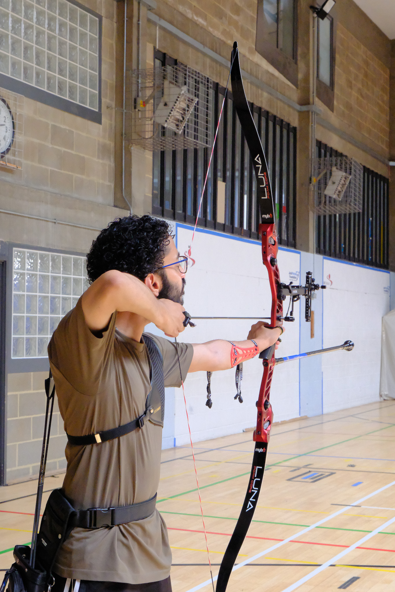 Full draw, side profile, indoor range