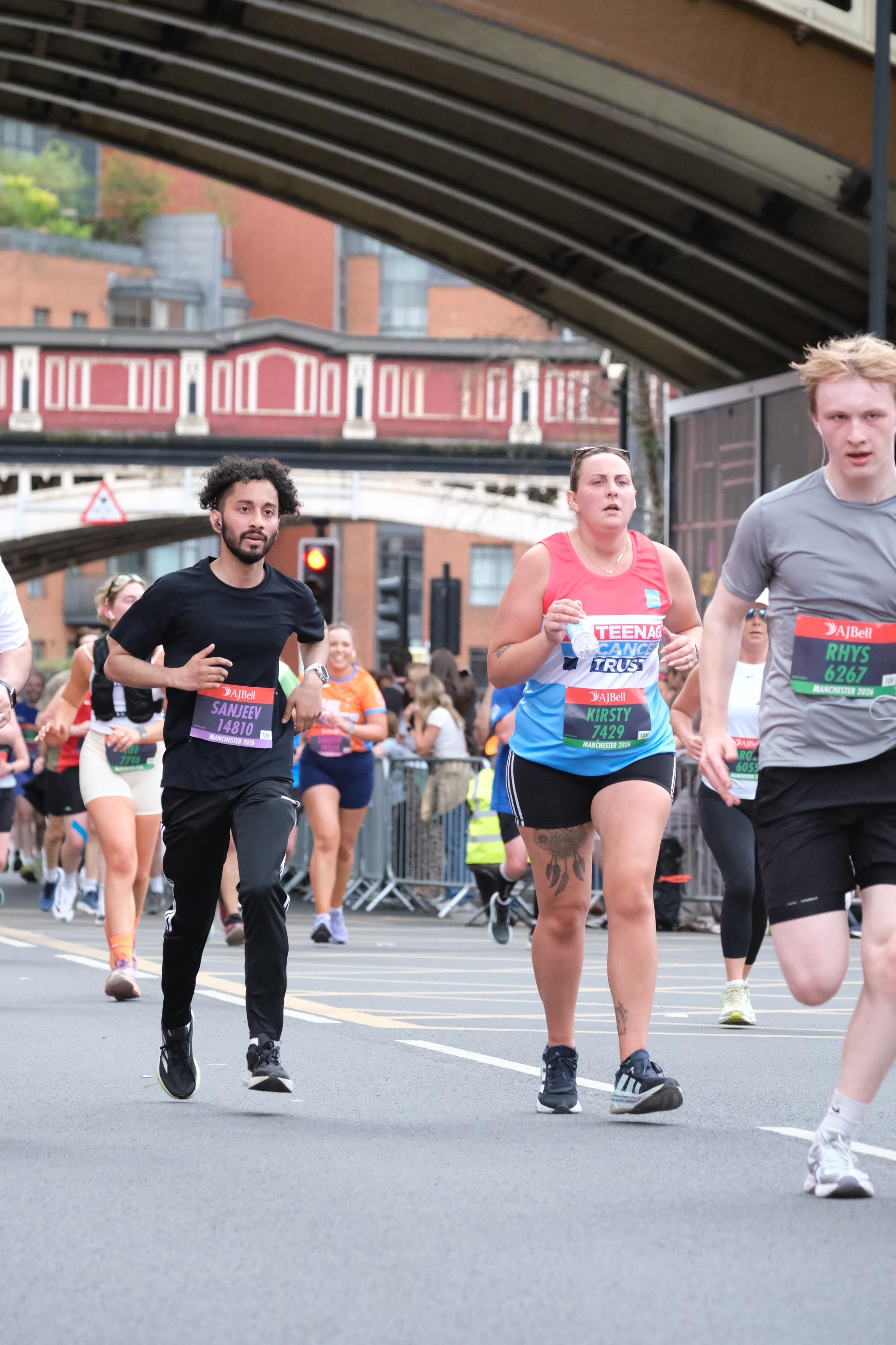 In the pack with fellow runners crossing a bridge in Manchester